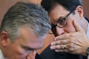 BNY Mellon's Chairman and CEO Kelly whispers to NYSE Euronext's CEO Niederauer at the Global Financial Forum in New York
