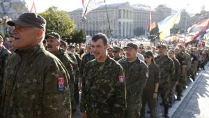 Members of the far-right radical group Right Sector, representatives of the Ukrainian volunteer corps and their supporters line up as they gather to march in central Kiev, Ukraine, July 3, 2015. The participants held a rally to demand from authorities to denounce the so-called Minsk peace agreements, to declare the military conflict in eastern Ukraine a war, to equip volunteer battalions by up-to-date standards and to break off diplomatic ties with Russia, according to local media. REUTERS/Valentyn Ogirenko  - RTX1IXCT