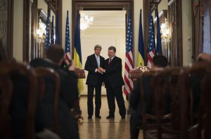 Ukraine's President Poreshenko shakes hands with U.S. Secretary of State Kerry after delivering a statement following a bilateral meeting in Kiev